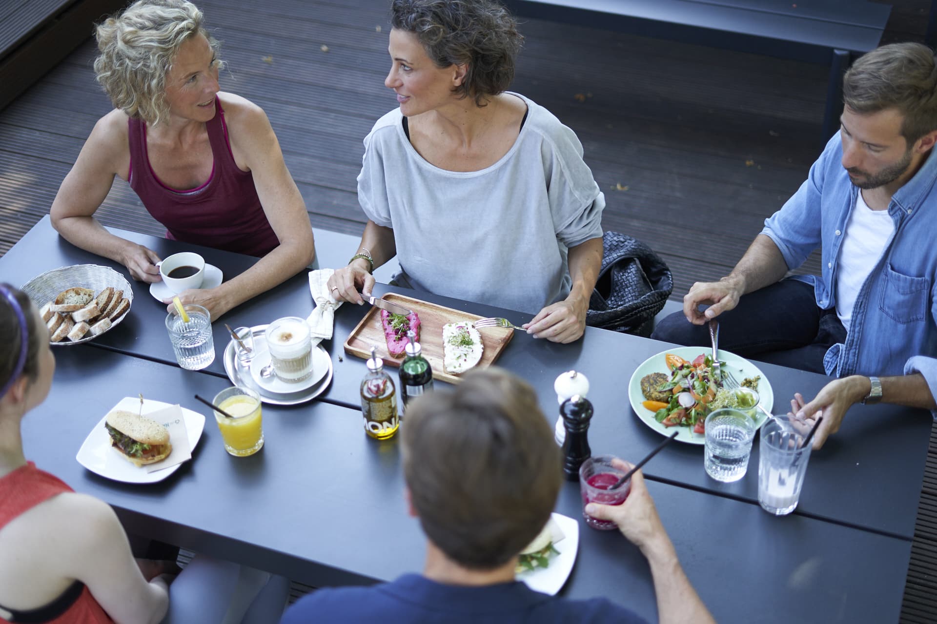 Guests of a restaurant sit together at a table in the restaurant of a gym