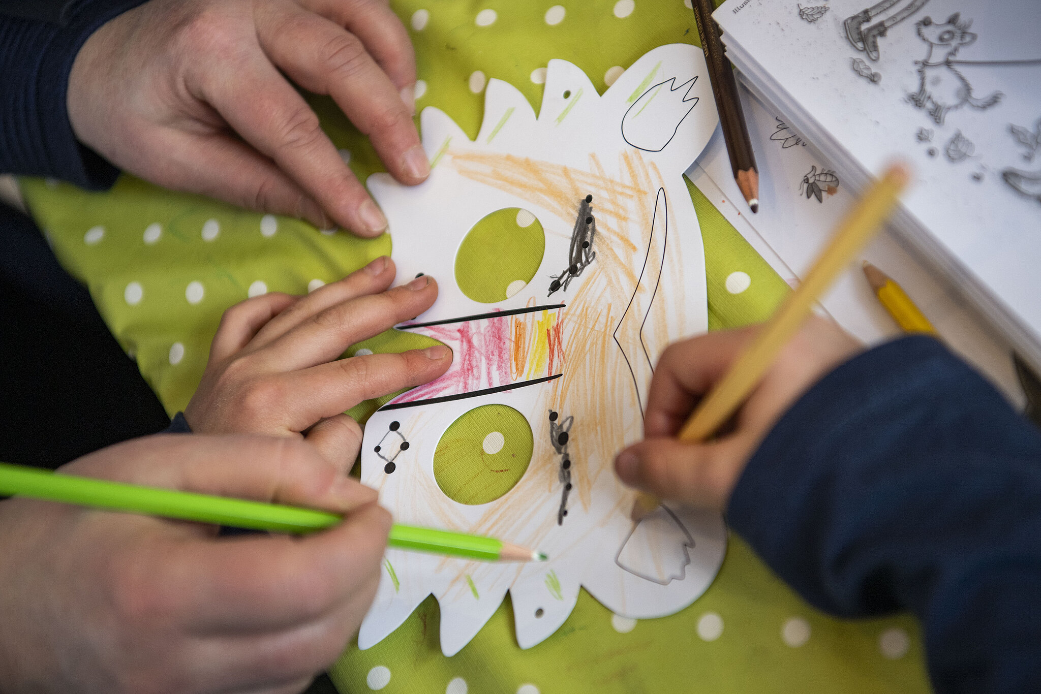 A child paints a mask during childcare
